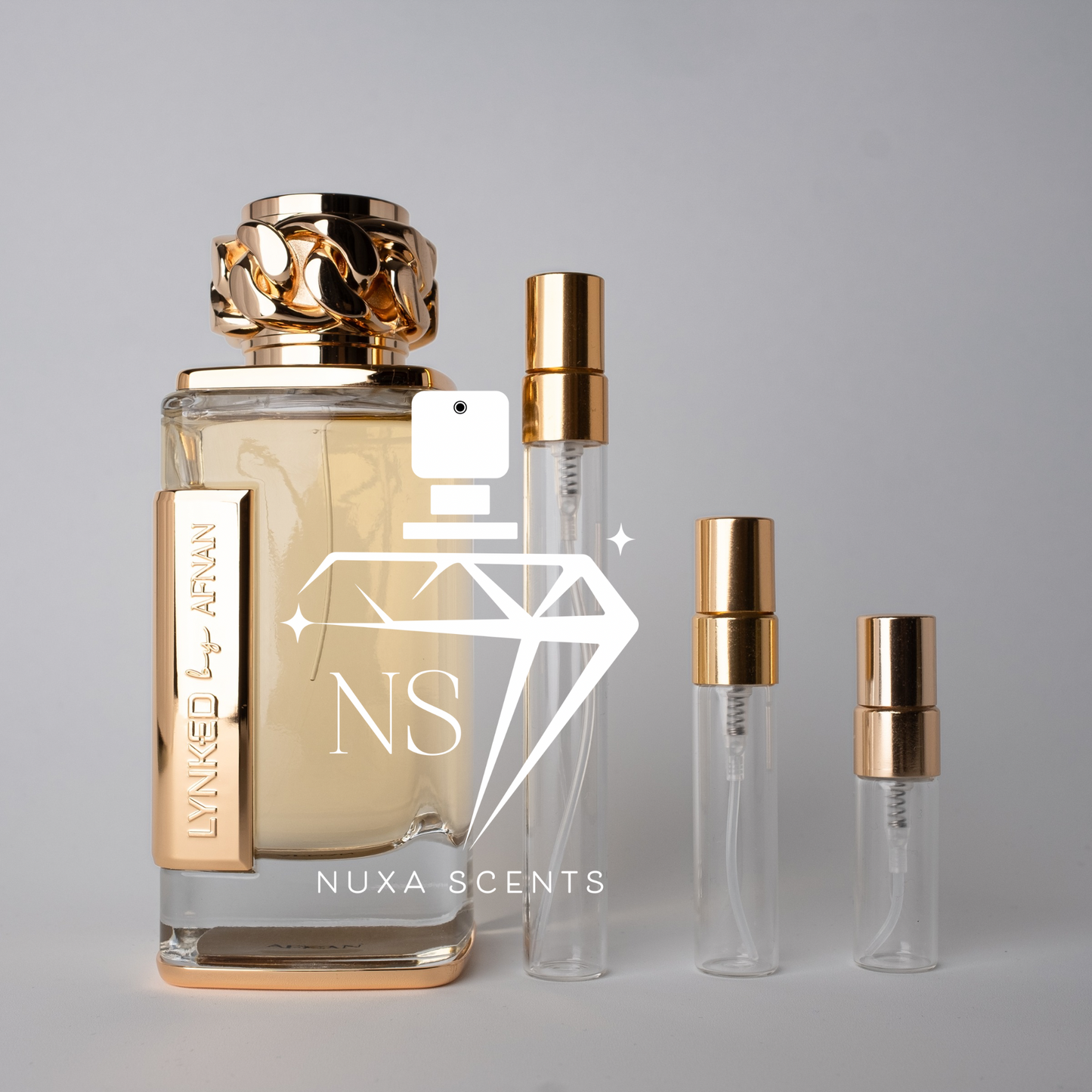 perfume bottle with gold cap and clear bottles on a gray background