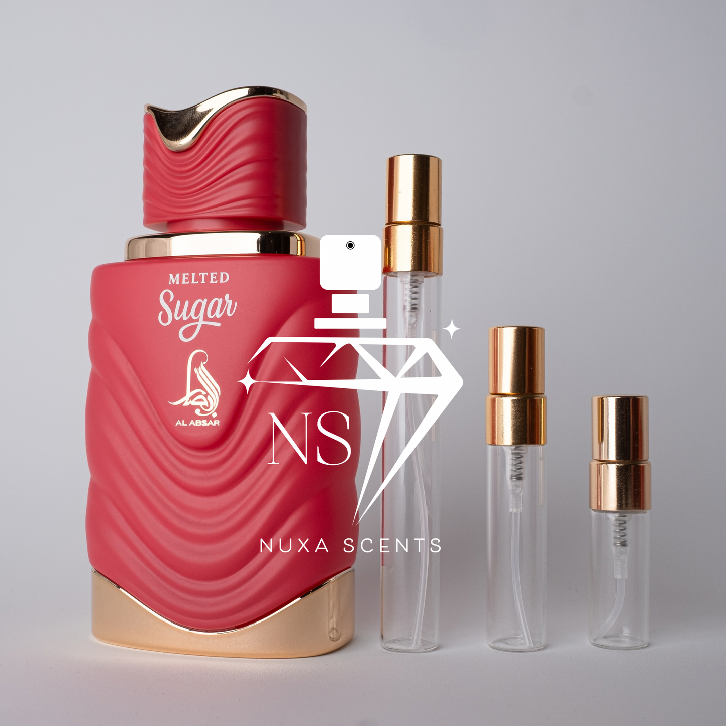 Red perfume bottle with gold accents and clear bottles labeled 'Nuxa Scents' on a gray background