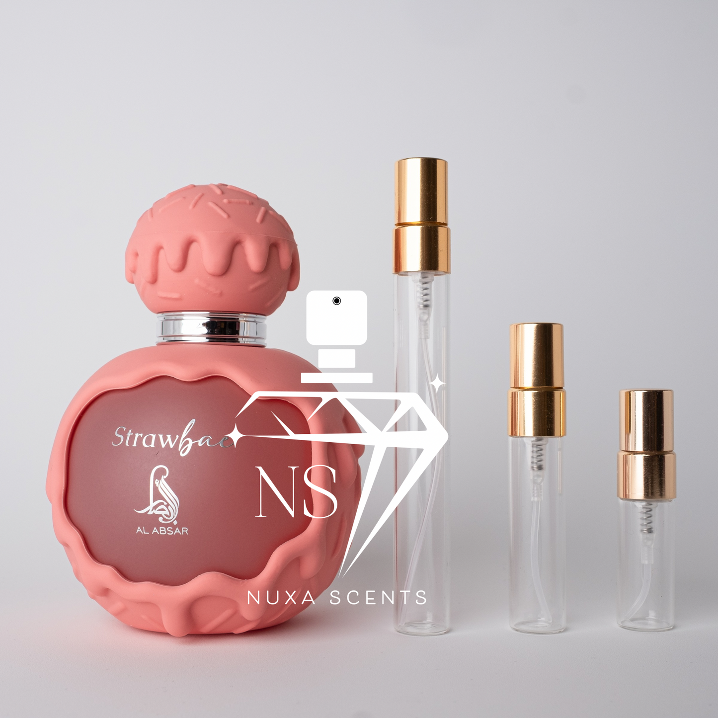 Pink perfume bottle with gold cap and 'Nuxa Scents' branding on a light gray background