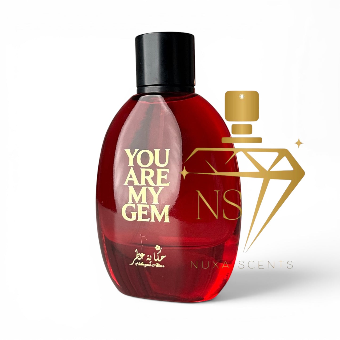 A red perfume bottle with a black cap and gold lettering that reads 'YOU ARE MY GEM'. A large gold diamond-shaped logo overlay with 'NS' and the text 'NUXA SCENTS' is positioned to the right of the bottle on a white background.