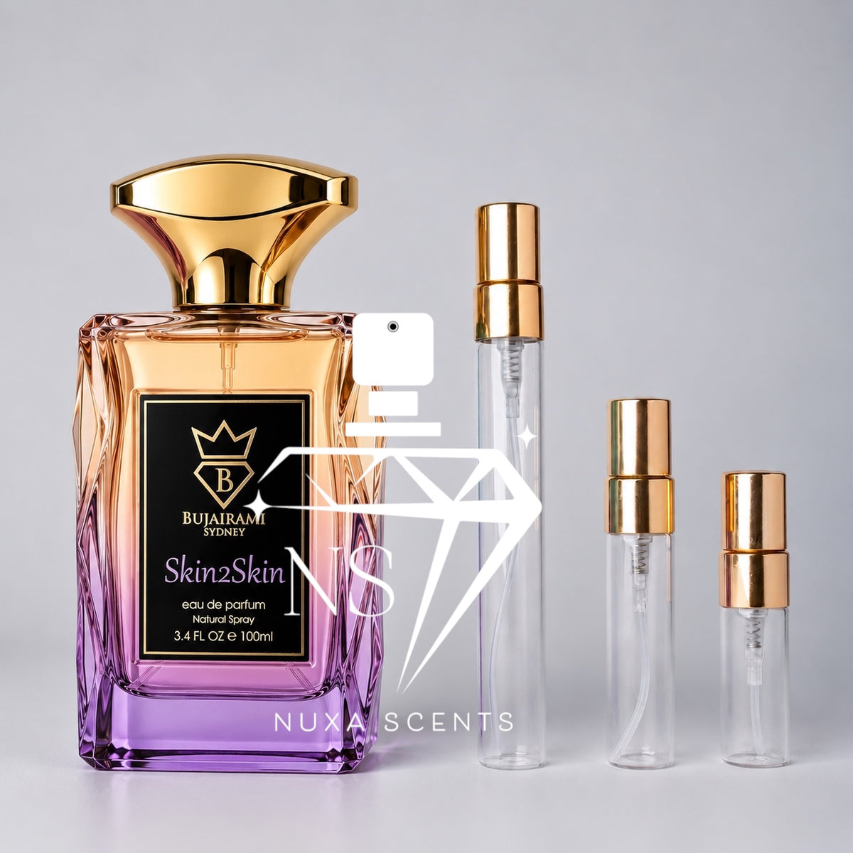 Bujairami Sydney Skin2Skin 100ml Eau de Parfum bottle featuring peach-to-lilac gradient glass, a sculpted gold cap and black-and-gold label, displayed beside three clear perfume sample decant spray bottles with gold atomisers on a clean light-grey studio background.