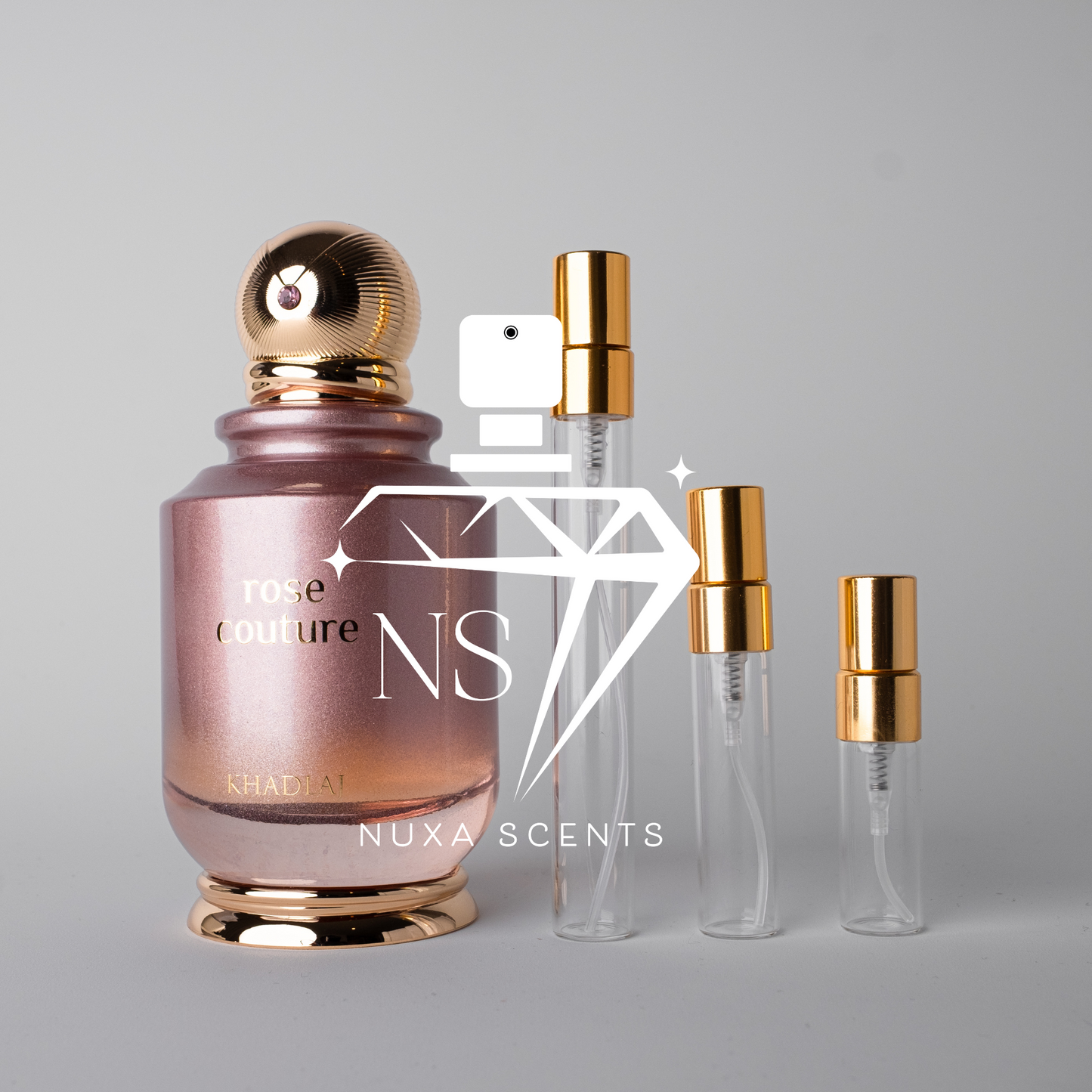 Nuxe Scents rose couture perfume bottle with gold cap on a gray background
