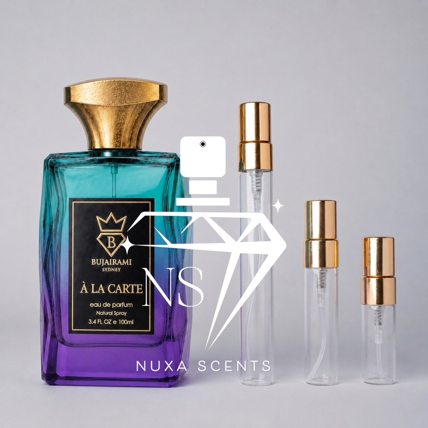A perfume bottle with a blue-to-purple gradient label and a gold cap stands next to three clear glass sample vials with gold spray tops on a light gray background. A large semi-transparent 'NS' watermark and the text 'NUXA SCENTS' are overlaid across the center.