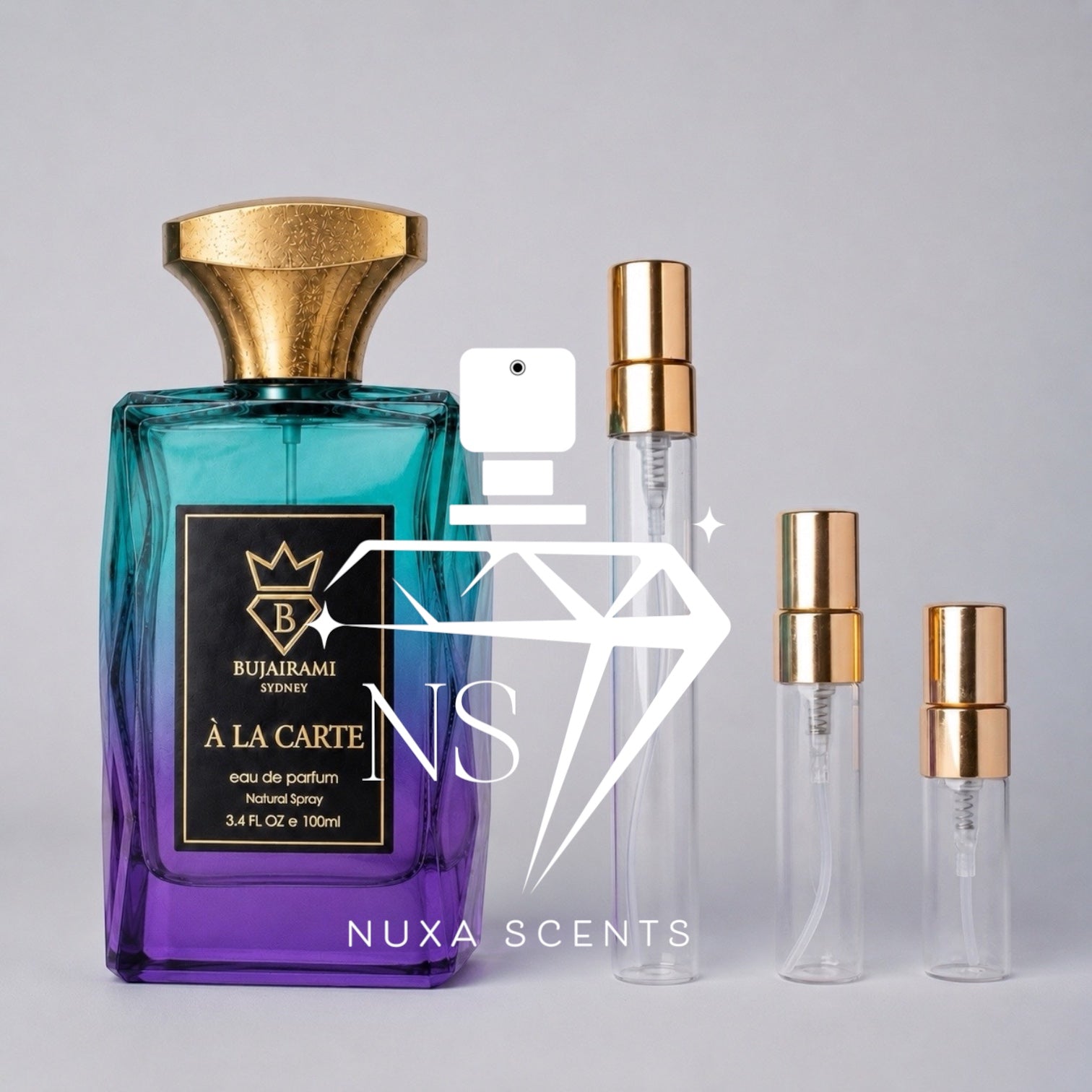 A perfume bottle with a blue-to-purple gradient label and a gold cap stands next to three clear glass sample vials with gold spray tops on a light gray background. A large semi-transparent 'NS' watermark and the text 'NUXA SCENTS' are overlaid across the center.