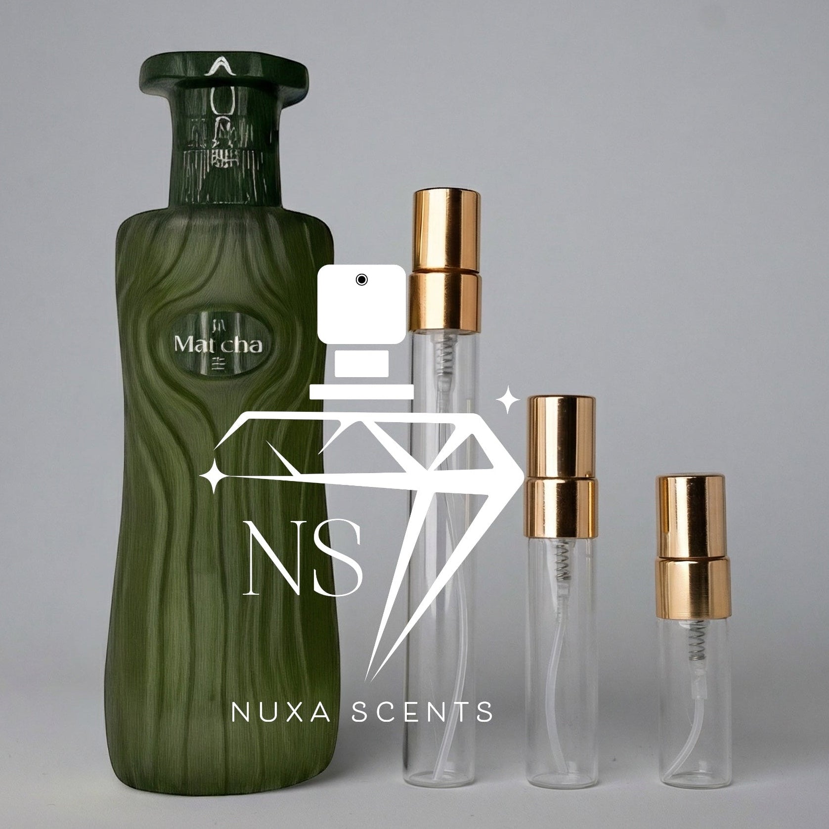 Green perfume bottle and three clear bottles with gold caps on a gray background, featuring Nuxa Scents logo.
