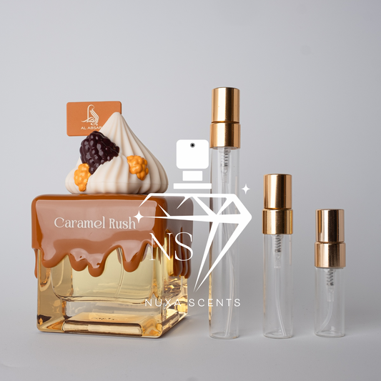 Perfume bottle labeled 'Caramel Rush' by Nuxx Scents with two smaller bottles on a gray background.