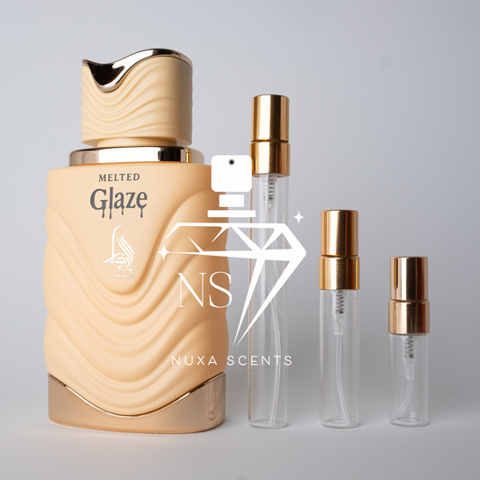 Perfume bottle labeled 'Melted Glaze' by Nuxa Scents with two smaller bottles on a gray background.
