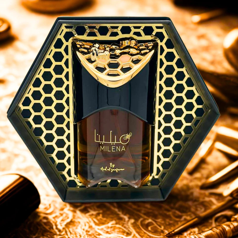 Perfume bottle with gold and black design on a textured surface