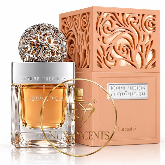 Beyond Precious Rose perfume bottle with amber liquid and a silver cap, displayed next to its peach-colored ornate box. A gold ring watermark is overlaid across the center.