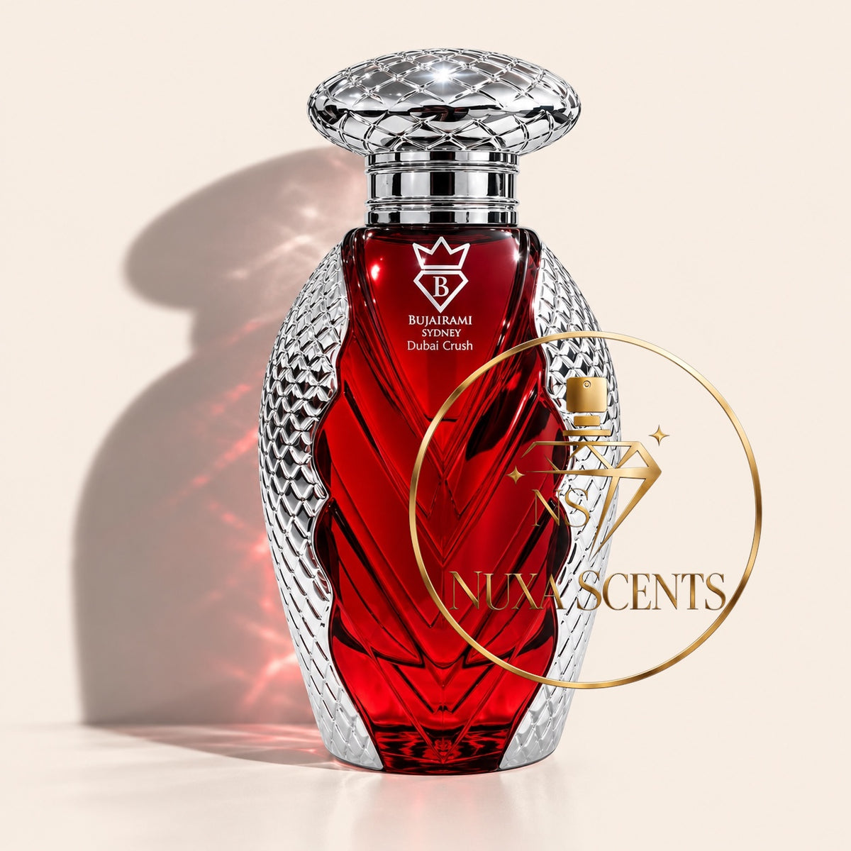 A luxury perfume bottle with a faceted silver crystal body and a deep red glass center, featuring the brand name 'RUMAMI' and 'Delicate Crush' printed on the front. A gold watermark for 'NuxaScents' is overlaid on the right side, set against a warm beige background with a soft shadow.