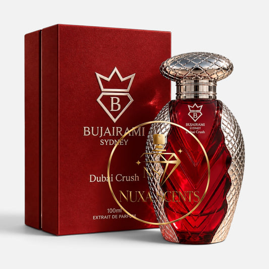 Bujairami Sydney Dubai Crush extrait de parfum in a red faceted glass bottle with a textured gold cap, shown next to its red packaging box with gold lettering.