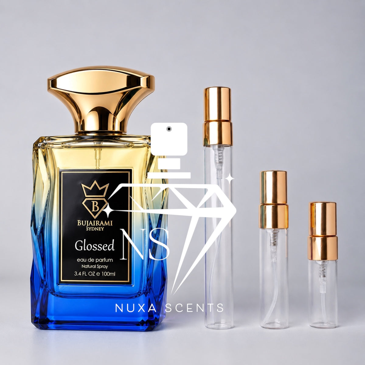 Bujairami Glossed Eau de Parfum 100ml bottle with a luxurious gold-to-vibrant-blue gradient glass design and sculpted gold cap, displayed beside three clear gold-capped perfume sample decants in different sizes on a clean light-grey studio background.