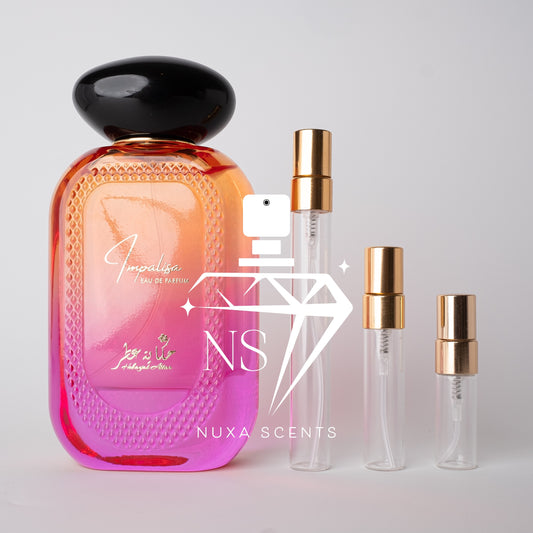 Perfume bottle with black cap and gradient design, accompanied by smaller bottles and 'Nuxa Scents' branding.