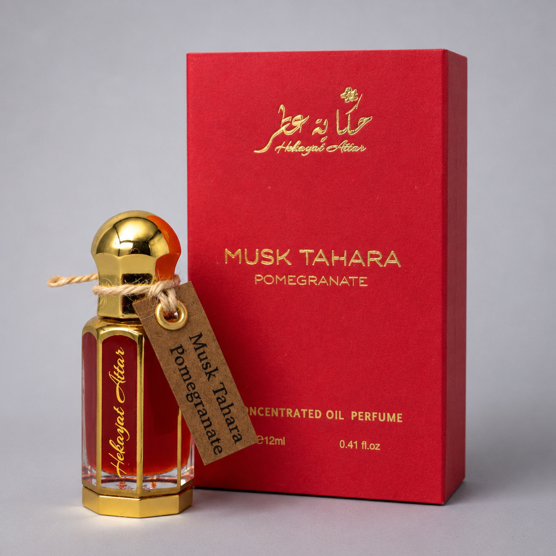 Perfume bottle and packaging of Musk Tahara Pomegranate on a gray background