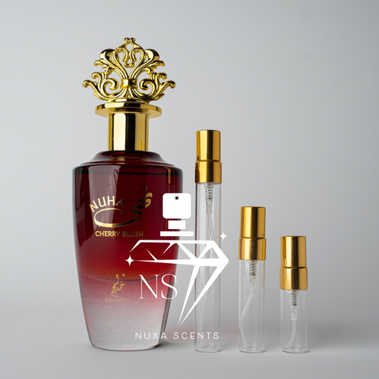 Perfume bottle with gold cap and red gradient design, featuring Nusa Scents branding.