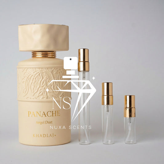 Perfume bottle with gold cap and 'Nuxa Scents' branding on a gray background