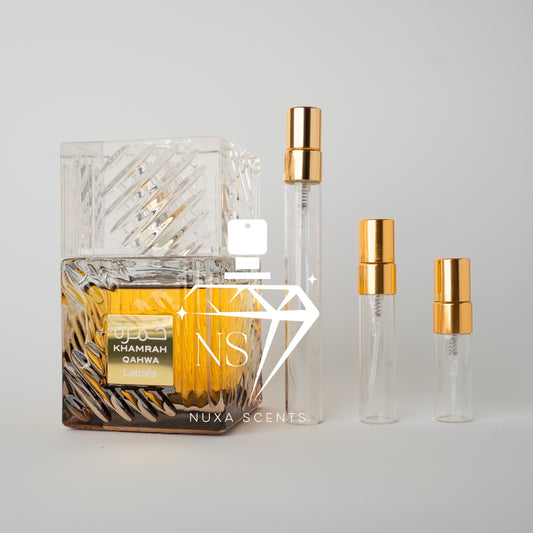 Perfume bottle with gold cap and clear container on a light gray background