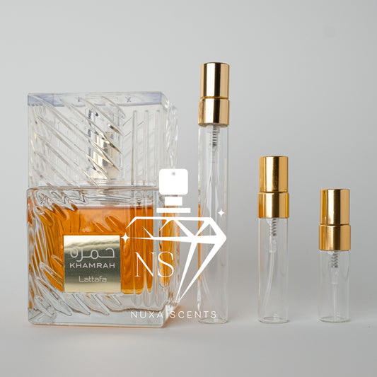 Perfume bottles with gold caps and a clear bottle on a gray background, featuring lattafa branding.