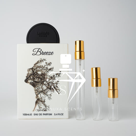 Perfume bottle with black caps and white packaging on a light gray background