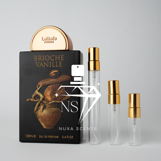 lattafa Brioche Vanille perfume packaging with gold caps on a gray background