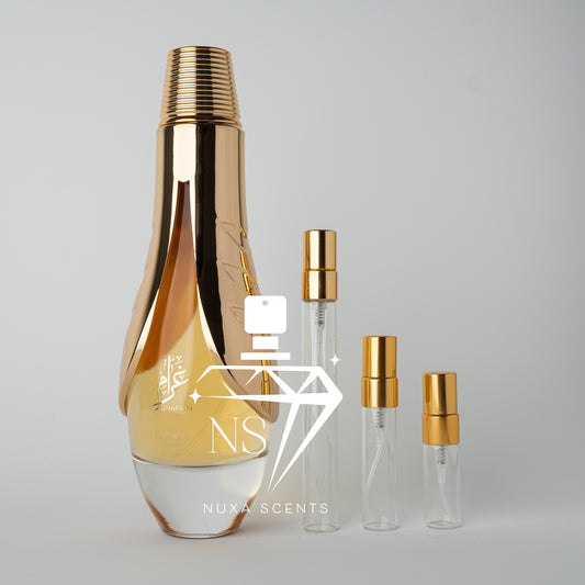 Set of lattafa pride Gharam perfume bottles with gold caps on a gray background