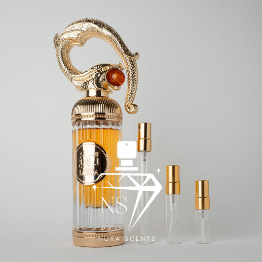 Luxury perfume bottle with gold accents and lattafa branding on a gray background