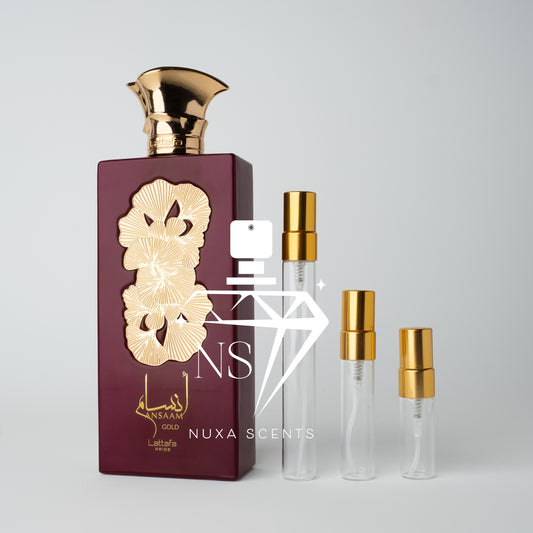 Perfume bottle with gold cap and maroon packaging, featuring Nuxa Scents branding.