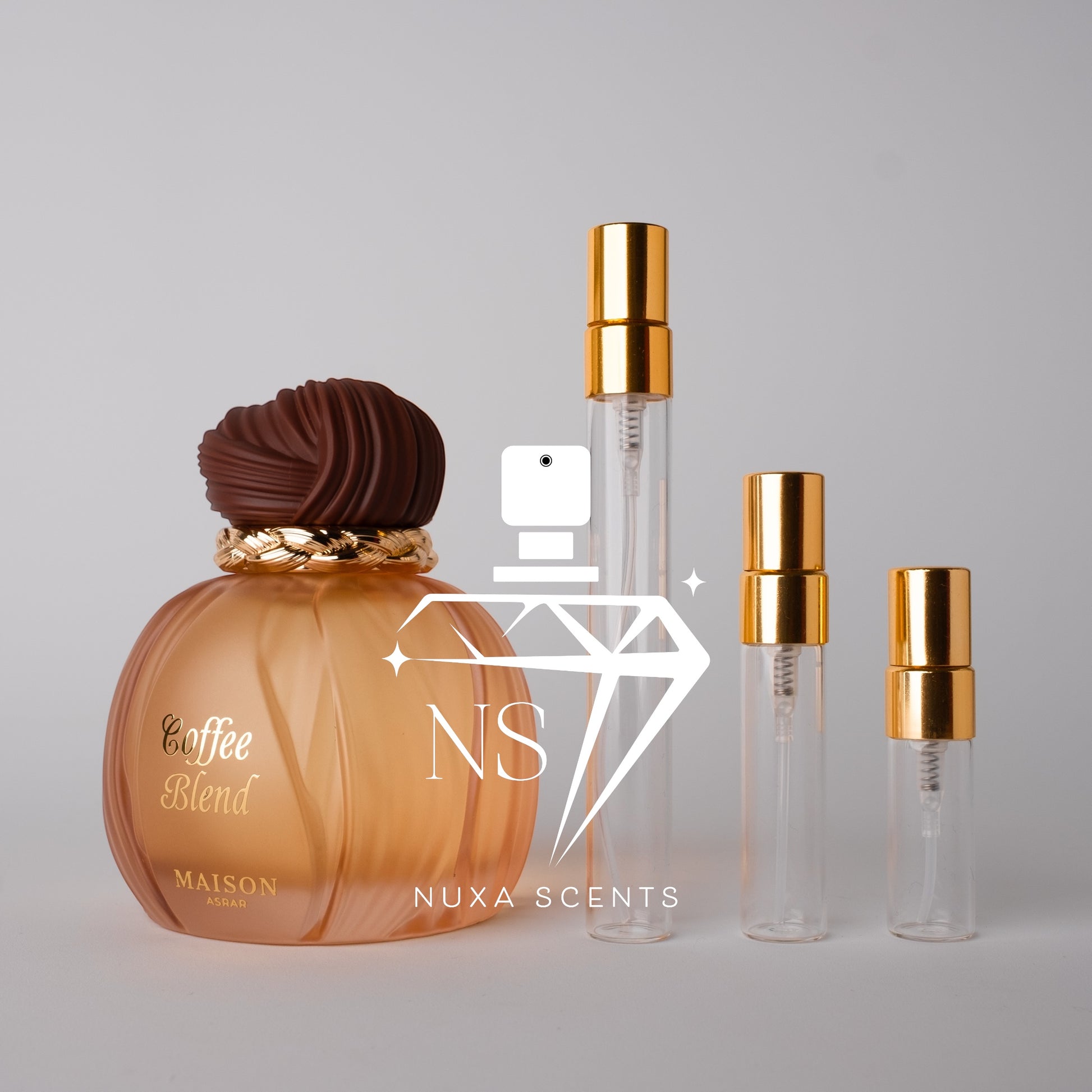 Perfume bottle labeled 'Coffee Blend' by Maison Asrar with gold caps on a gray background