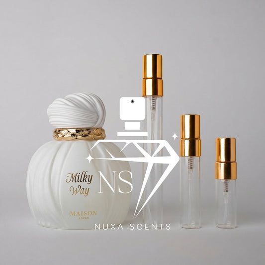 Perfume bottle and travel-sized bottles with gold caps on a gray background, featuring 'Nuxa Scents' branding.