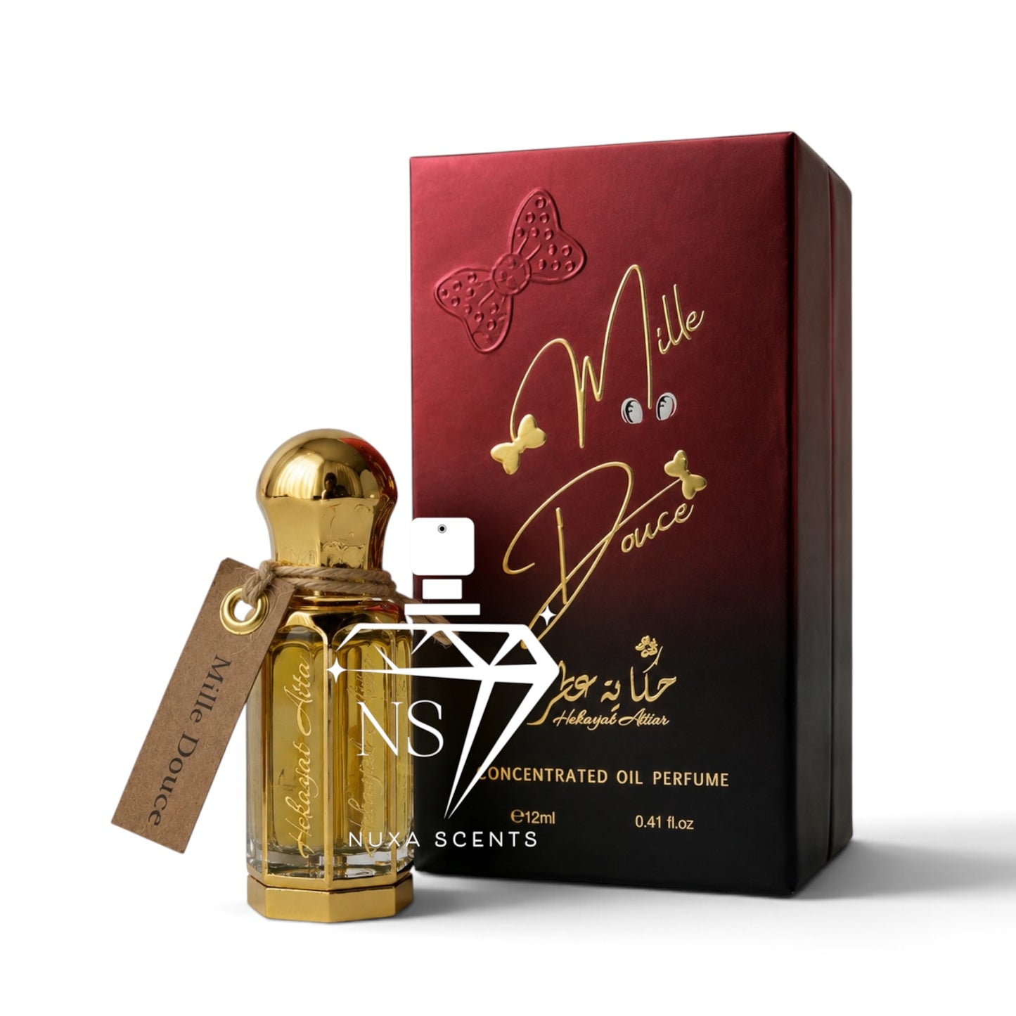 A bottle of Mille Douce perfume oil with a gold cap and a brown paper tag, shown next to its dark red and black gradient box with gold lettering. The brand 'NUXA SCENTS' is visible on the hangtag and the bottle.