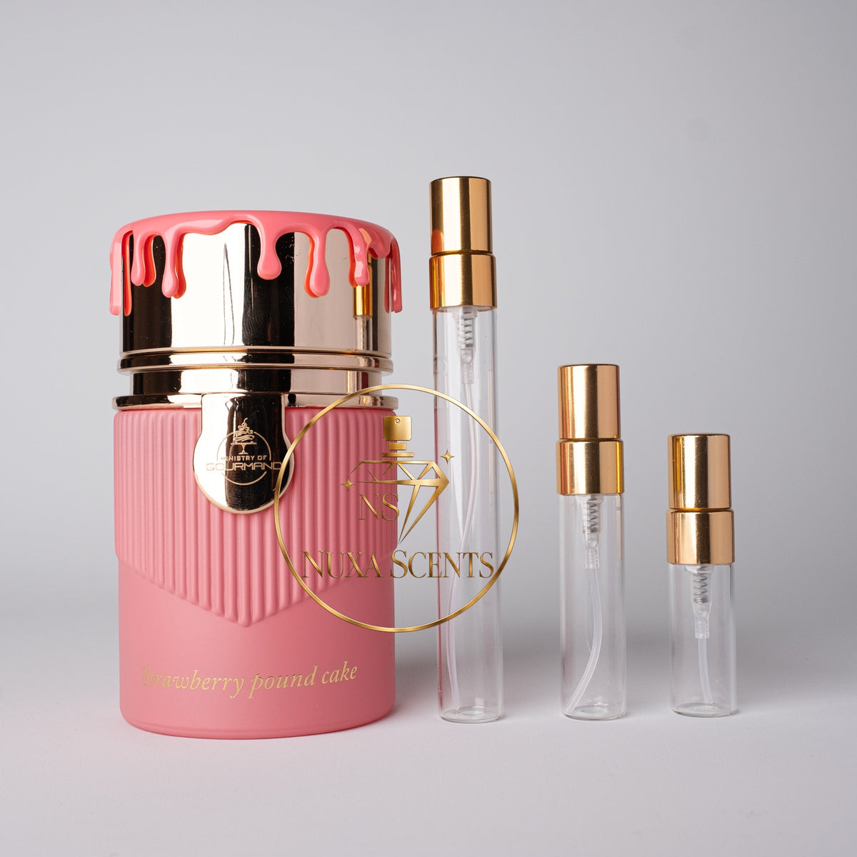 A pink cylindrical perfume bottle with a gold and pink dripping lid, shown next to three clear glass perfume atomizer vials with gold caps on a light gray background. The bottle features a gold logo overlay for 'Nina Scents' and the scent name 'Strawberry Pound Cake' is printed on the front.