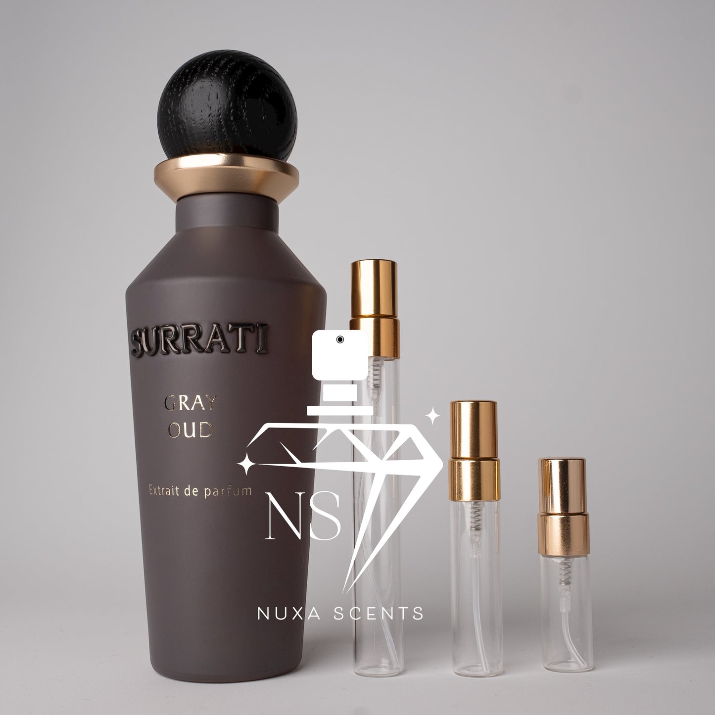 Surrati and perfume bottles on a gray background
