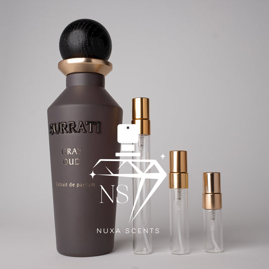 Surrati and perfume bottles on a gray background