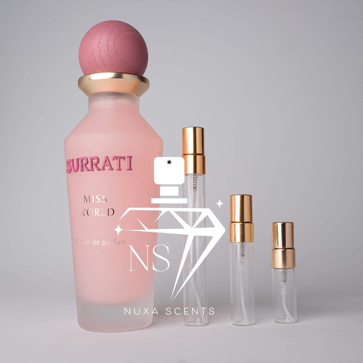 Pink Buratti perfume bottle with gold cap on a gray background