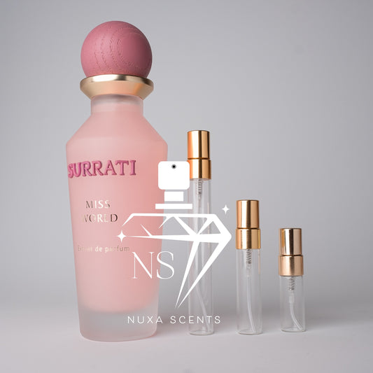 Pink Buratti perfume bottle with gold cap on a gray background