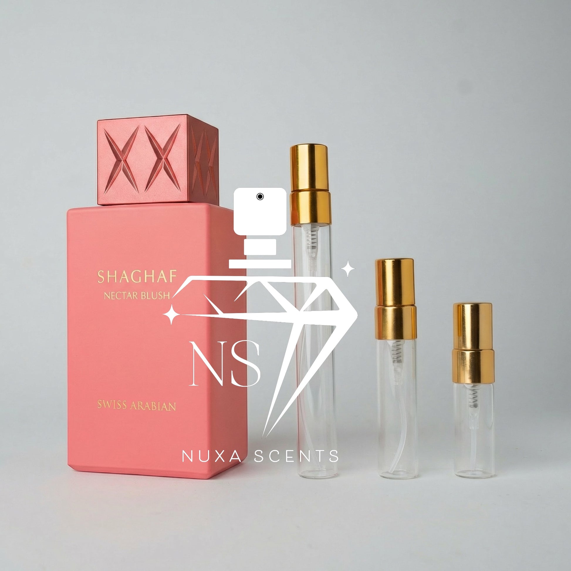 Pink perfume bottle with gold caps on a gray background