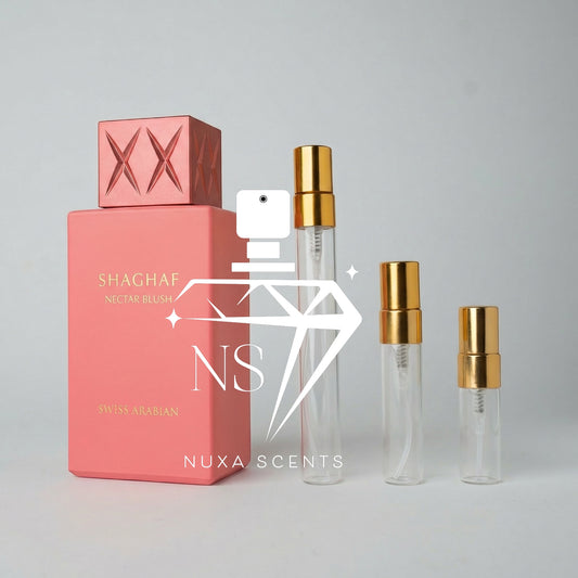 Pink perfume bottle with gold caps on a gray background