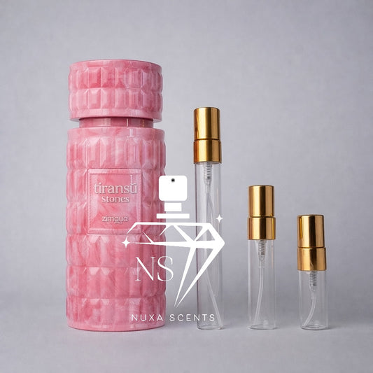 Pink textured perfume bottle with gold caps on a gray background