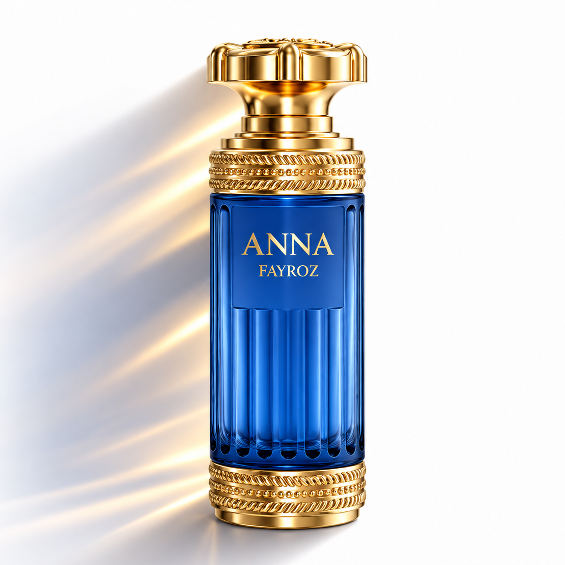 A luxury perfume bottle named 'ANNA FAYROZ' with a deep blue ribbed glass body and ornate gold metallic accents on the cap and collar, set against a clean white background with dramatic golden light rays.