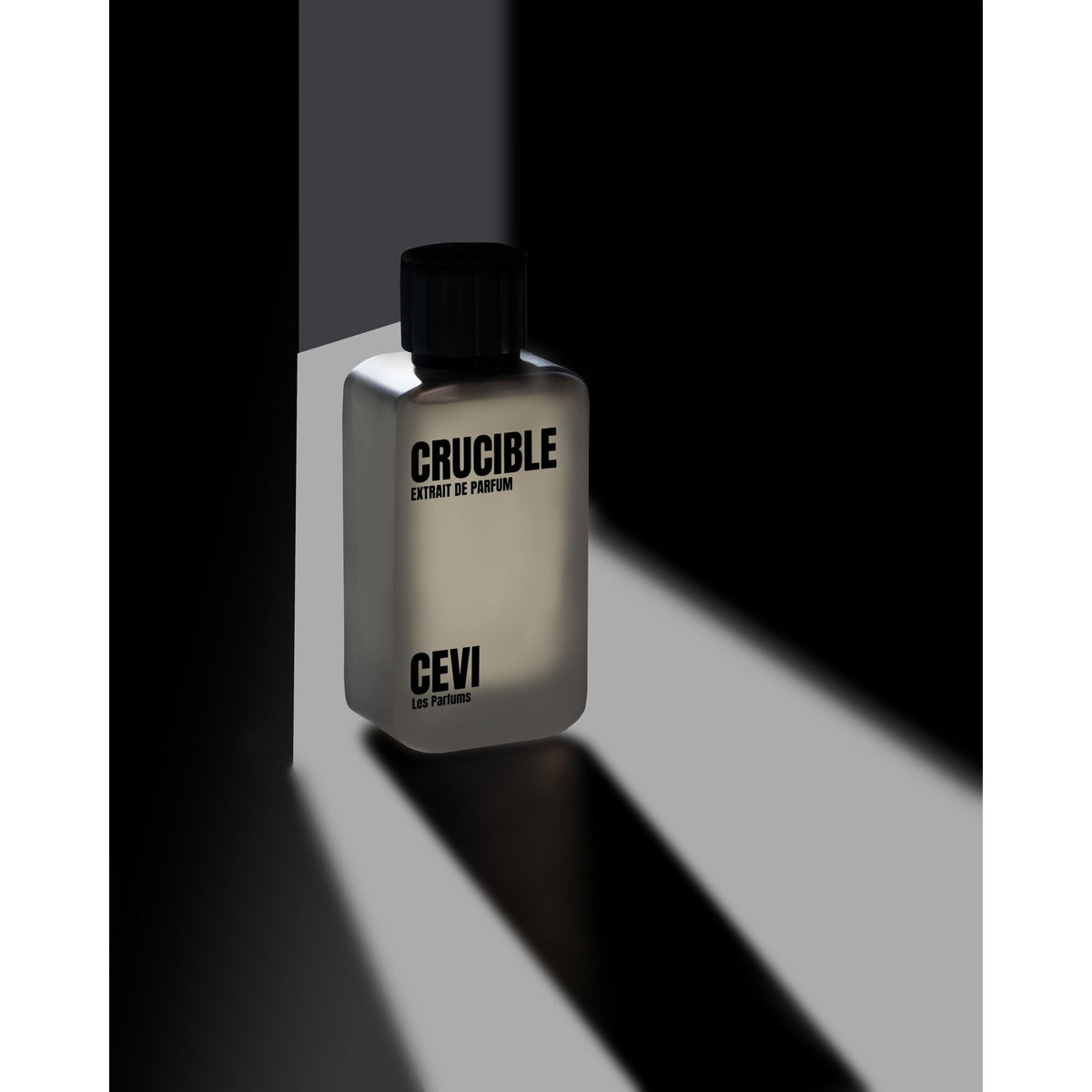 Crucible 100ml Extrait de Parfum bottle on a black and white diagonal background | Nuxa Scents