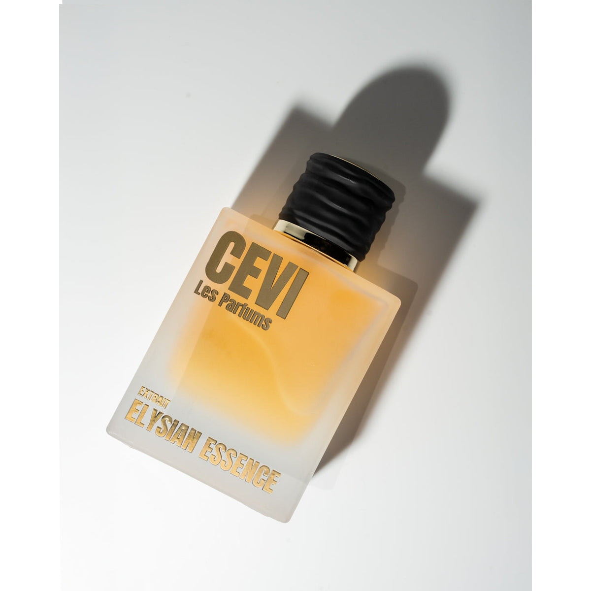 Elysian Essence by Cevi Les Parfums frosted bottle with black cap, angled with a long shadow