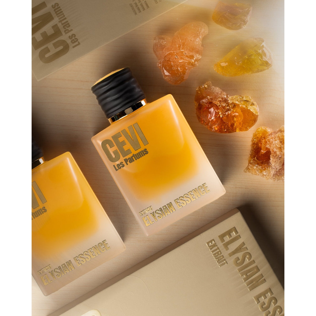 Elysian Essence by Cevi Les Parfums bottles and box styled with amber resin pieces