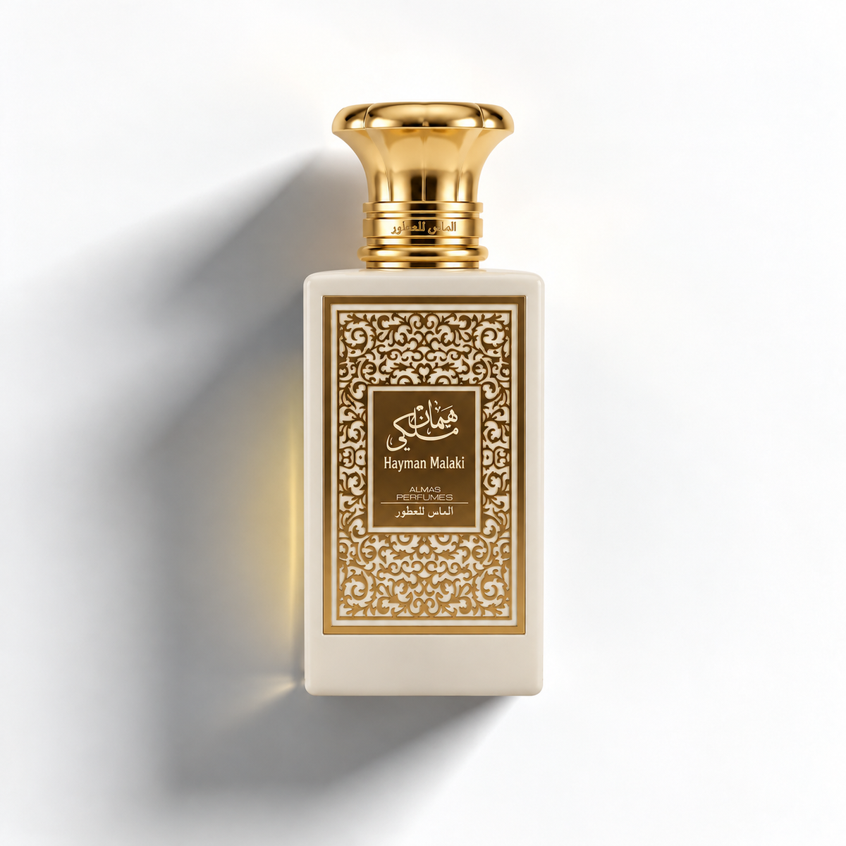 A rectangular perfume bottle with a cream-colored body, ornate gold filigree detailing on the front label, and a shiny gold cap, set against a clean white background with a soft shadow.