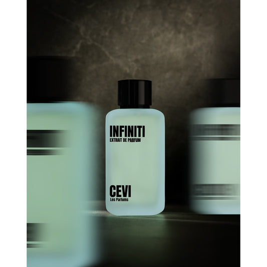 Three Infiniti by Cevi Les Parfums 100ml extrait de parfum bottles in a row against a dark background, centre bottle in focus