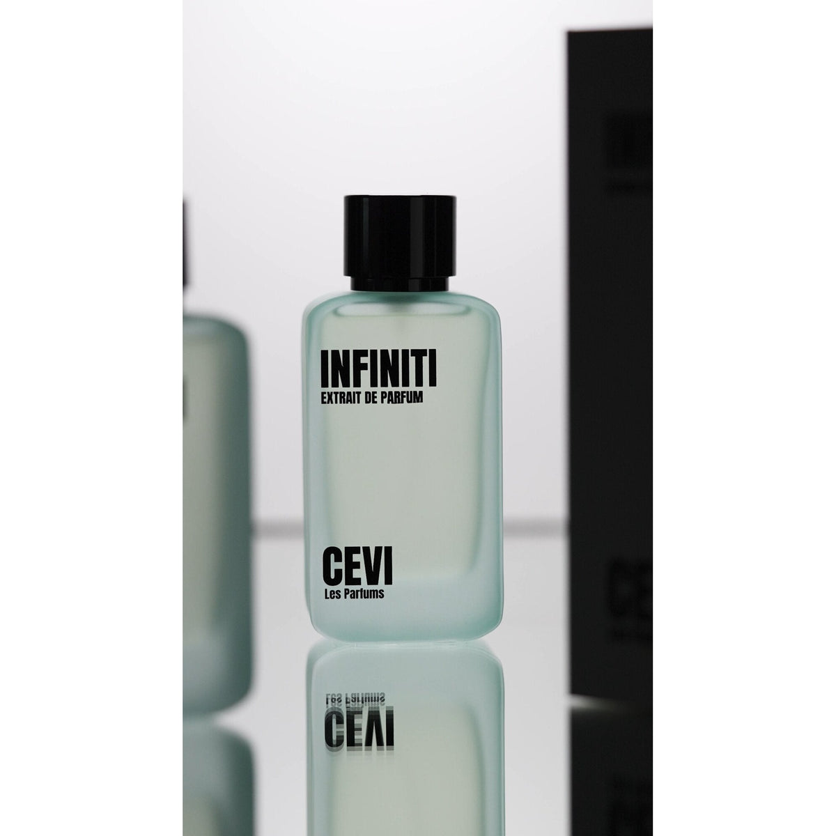 Infiniti by Cevi Les Parfums 100ml extrait de parfum bottle on a white studio background with a mirror reflection and dark side panel
