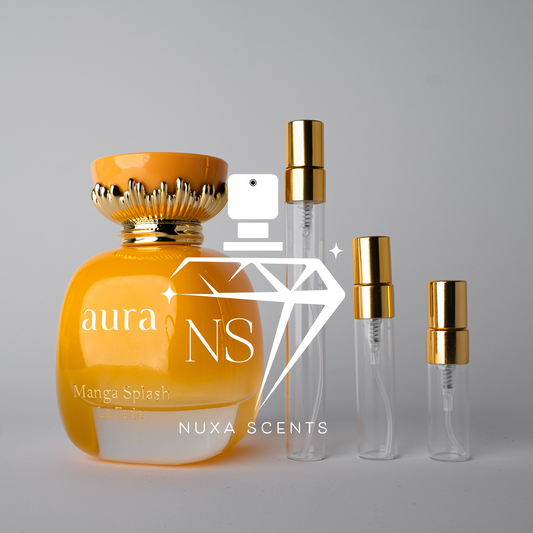 Orange perfume bottle with gold cap and clear bottles with gold caps on a gray background