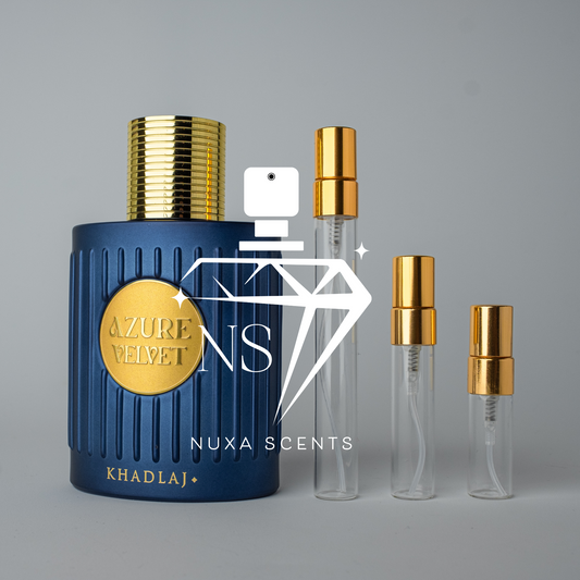 Blue perfume bottle with gold cap and 'Nuxa Scents' branding on a gray background