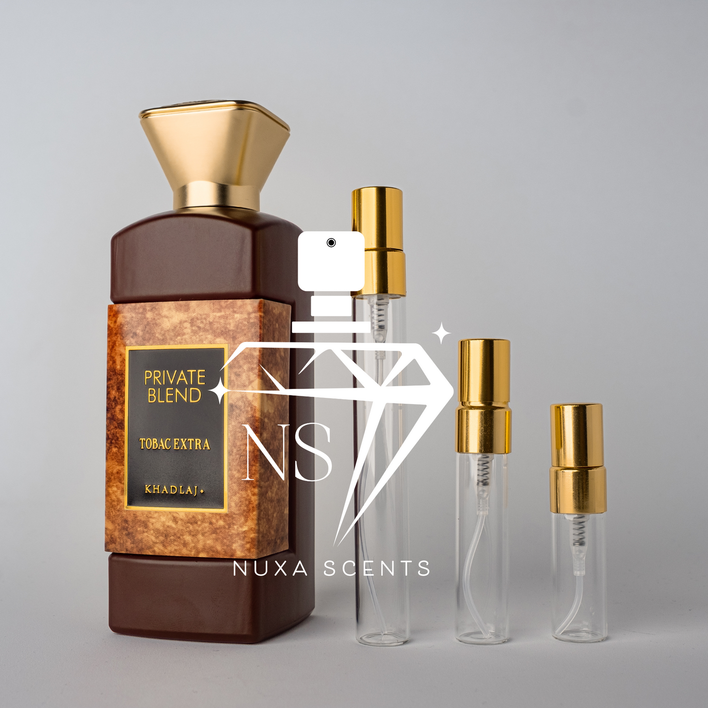 Perfume bottle with gold cap and brown label, alongside clear bottles with gold caps on a gray background.