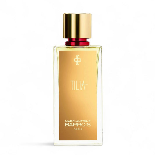 Gold perfume bottle with red atomizer and gold cap on a white background