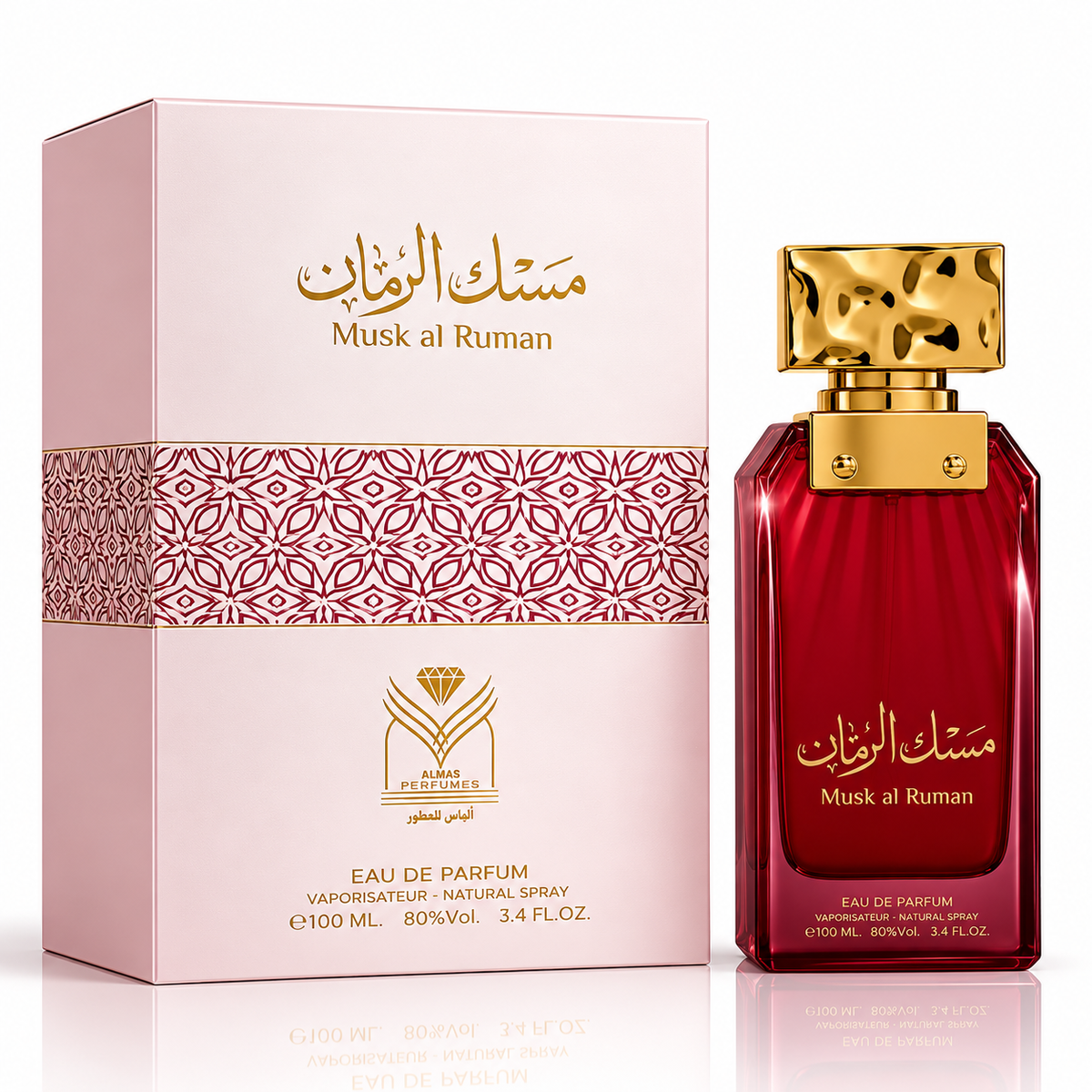 Musk al Ruman perfume bottle and its packaging box by Alhambra Perfumes. The bottle is deep red glass with a textured gold cap, and the box is light pink with a gold geometric pattern.